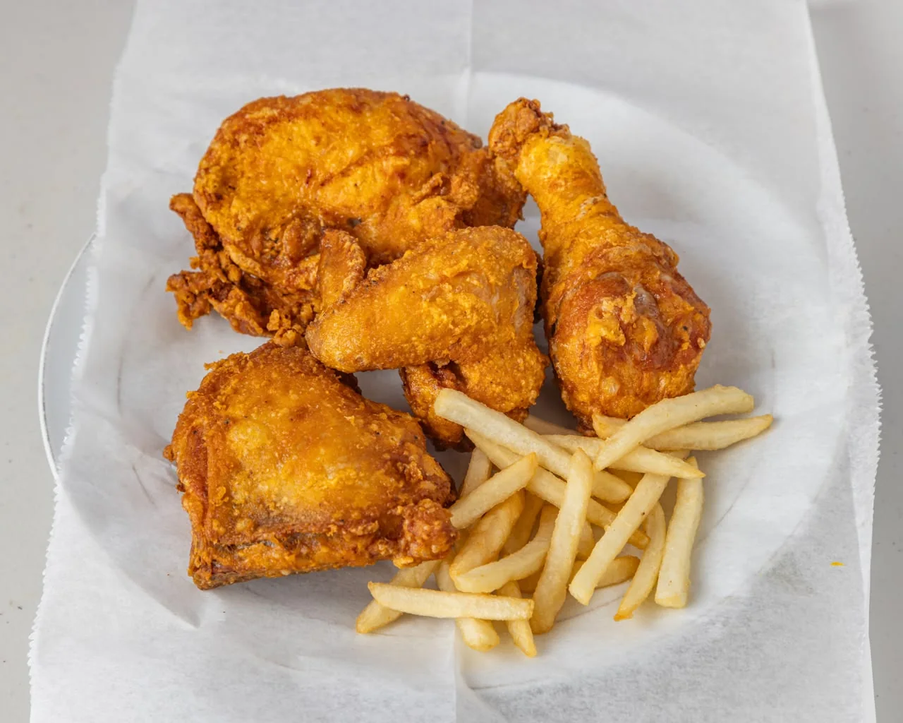 Crispy halal fried chicken pieces with fries