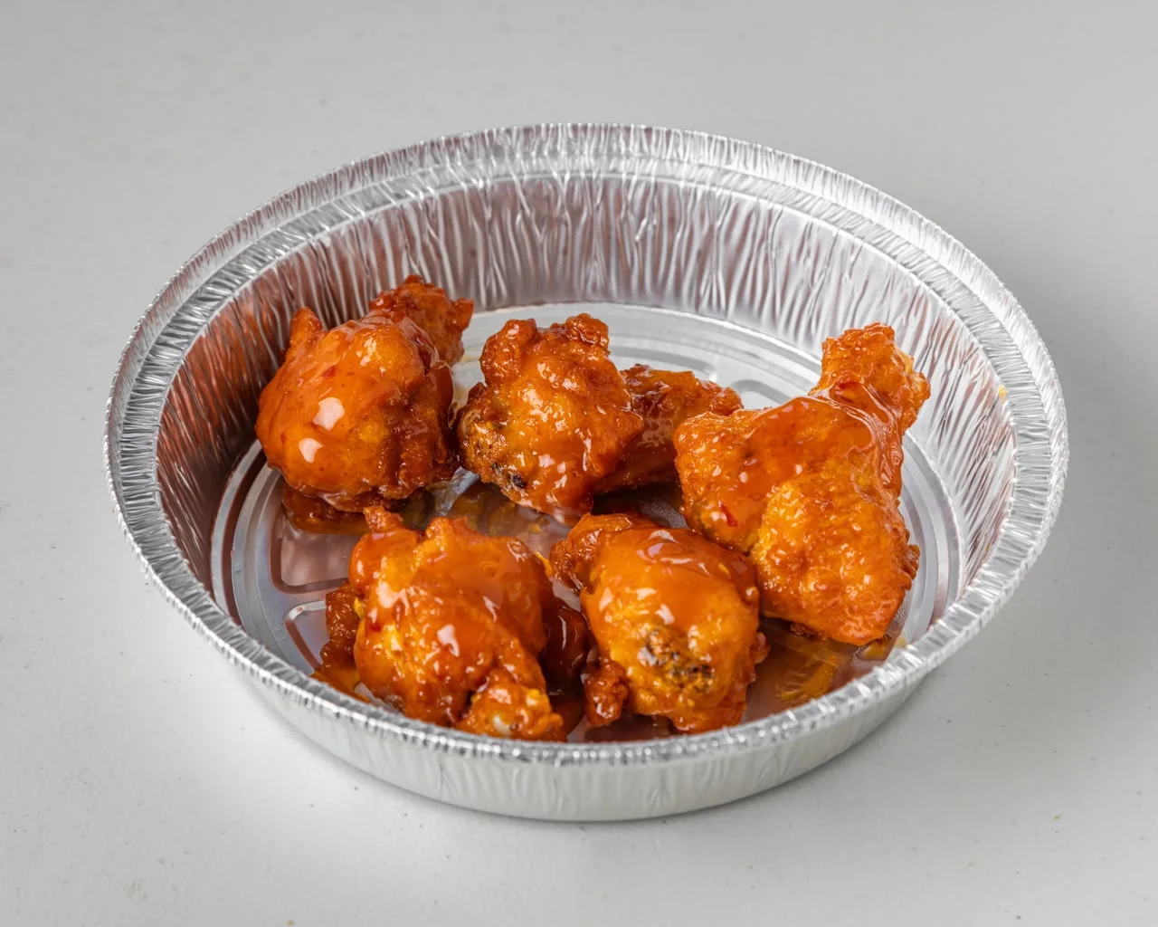 Halal hot wings tossed in sauce